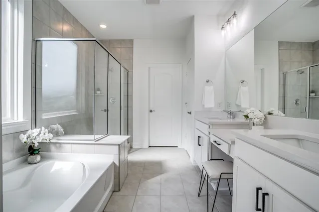 a spacious bathroom with a granite countertop tub sink and mirror