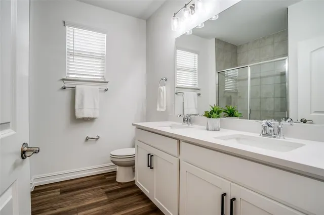 a bathroom with a sink toilet and a mirror