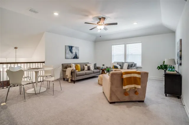 a living room with furniture and a chandelier