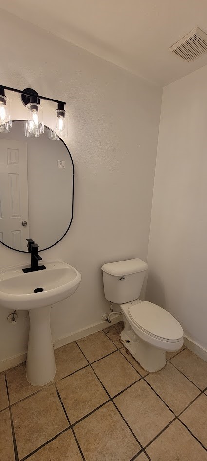 3116 Bolt Street Houston, TX 77051 - Photo 12 of 14 a bathroom with a toilet and a mirror