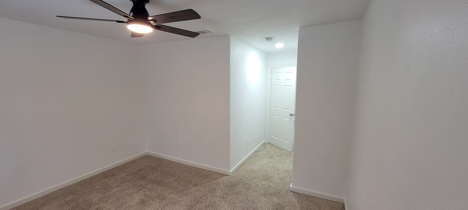 3116 Bolt Street Houston, TX 77051 - Photo 9 of 14 an empty room with a fan and a fan