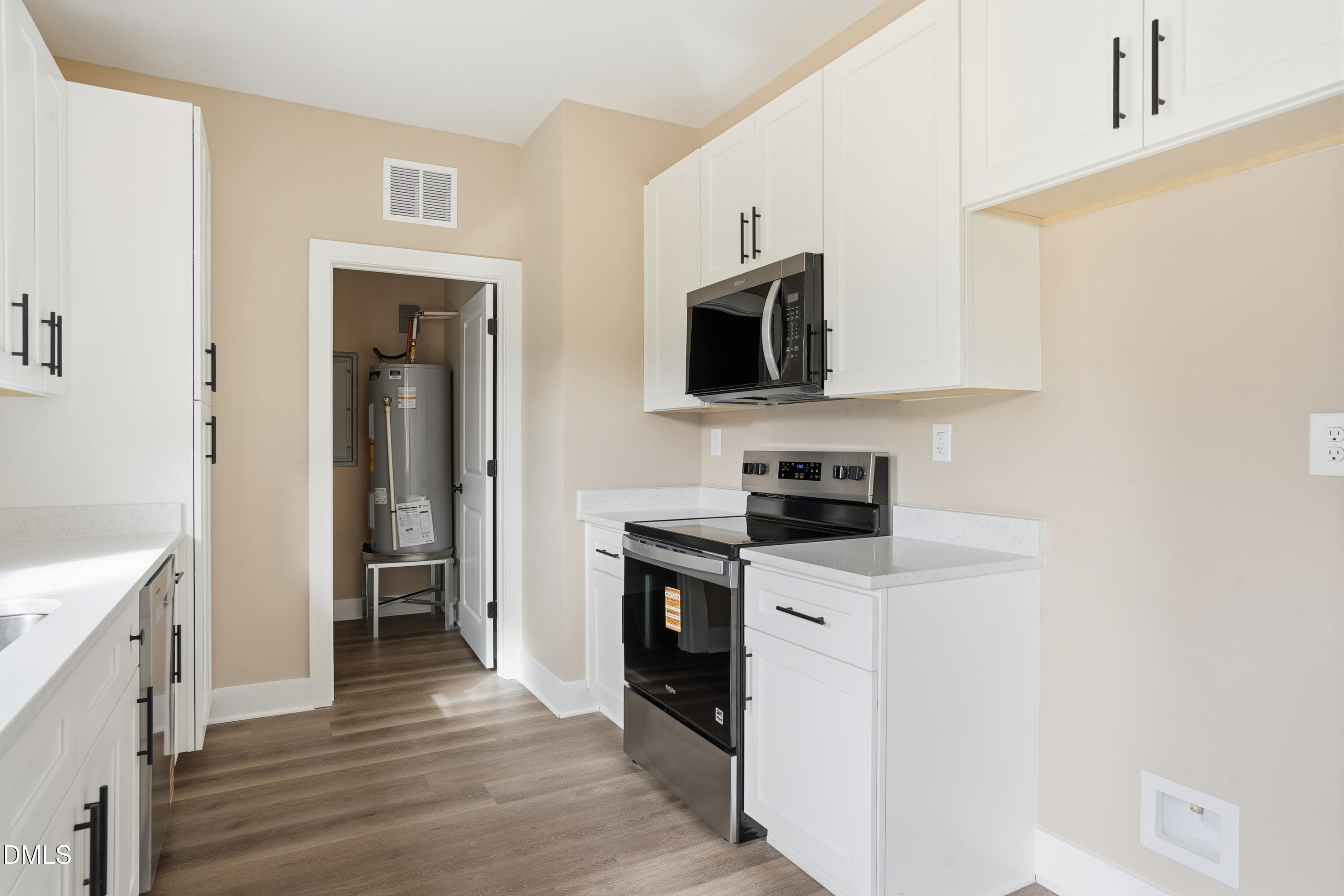 1115 Jada Allen Road Dunn, NC 28334 - Photo 11 of 32 a kitchen with stainless steel appliances a stove microwave and sink