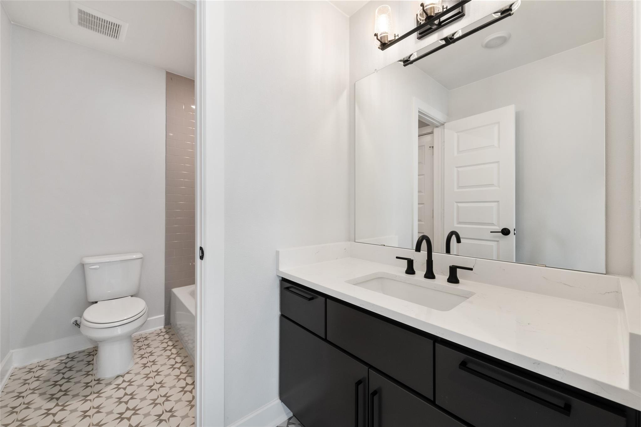 6216 Bower Well Road Austin, TX 78738 - Photo 28 of 31 a bathroom with a sink a toilet and a mirror