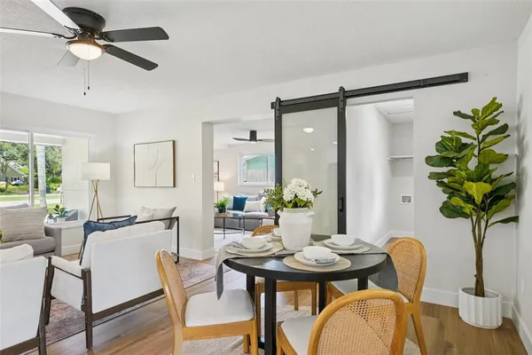 a view of a dining room with furniture and wooden floor