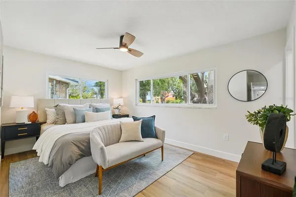 a bedroom with a bed and wooden floor