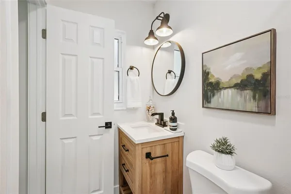 a view of a workspace with furniture and a potted plant