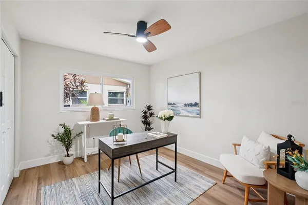 a bedroom with a bed a couch and a large window