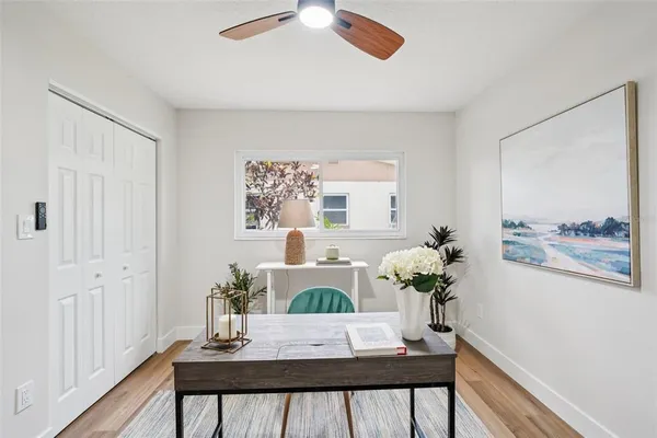 a bedroom with a bed and a painting on the wall