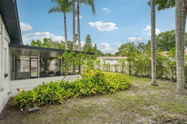 an aerial view of residential houses with outdoor space and lake view