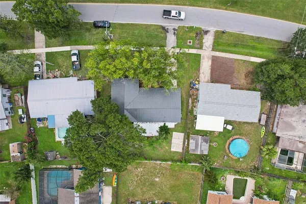 a front view of a house with a garden and trees