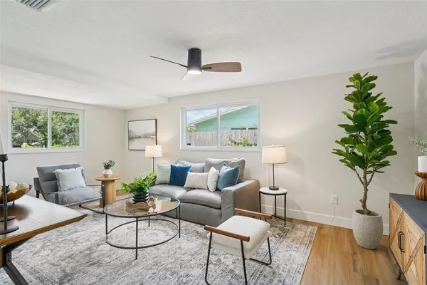 a living room with furniture a lamp and a window