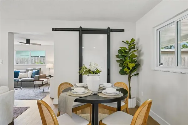 a view of a dining room with furniture and a potted plant