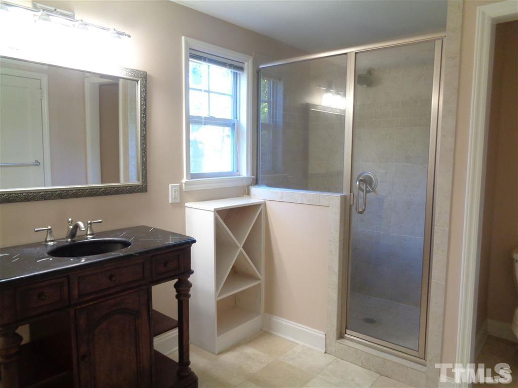 2901 Oberlin Road Raleigh, NC 27608 - Photo 10 of 18 a bathroom with a sink and a mirror