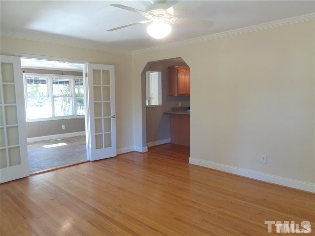 2901 Oberlin Road Raleigh, NC 27608 - Photo 13 of 18 an empty room with wooden floor cabinet and windows