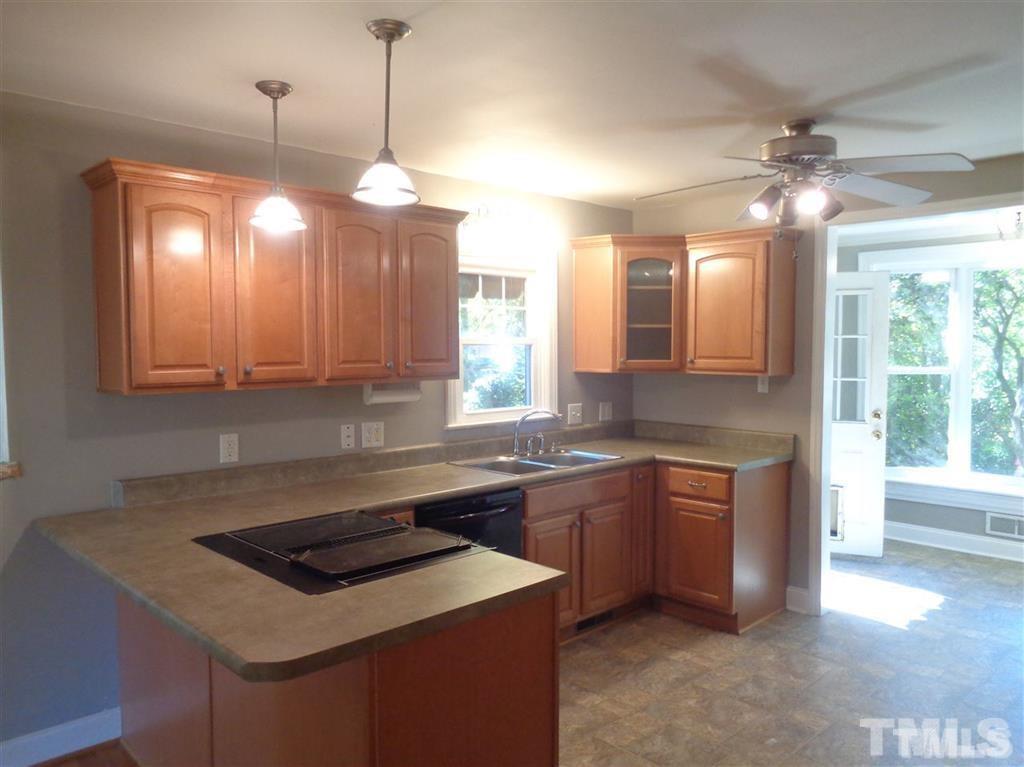 2901 Oberlin Road Raleigh, NC 27608 - Photo 3 of 18 a kitchen that has a sink a stove and a table