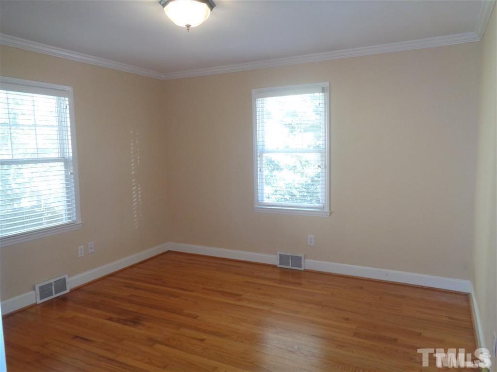 2901 Oberlin Road Raleigh, NC 27608 - Photo 8 of 18 an empty room with wooden floor and windows