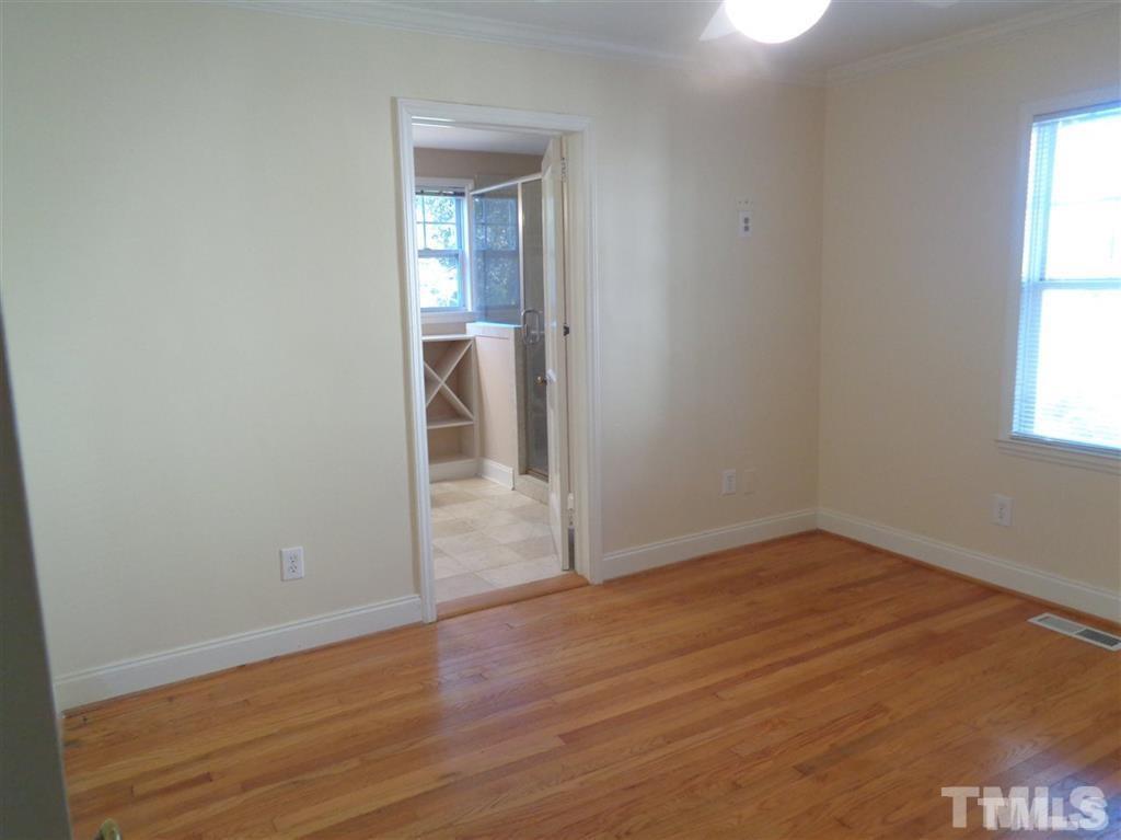 2901 Oberlin Road Raleigh, NC 27608 - Photo 9 of 18 an empty room with wooden floor and windows