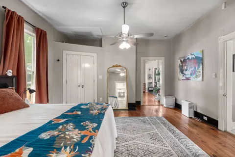 a bedroom with a bed and a chandelier