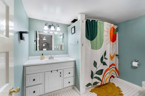 a bathroom with a sink and mirror