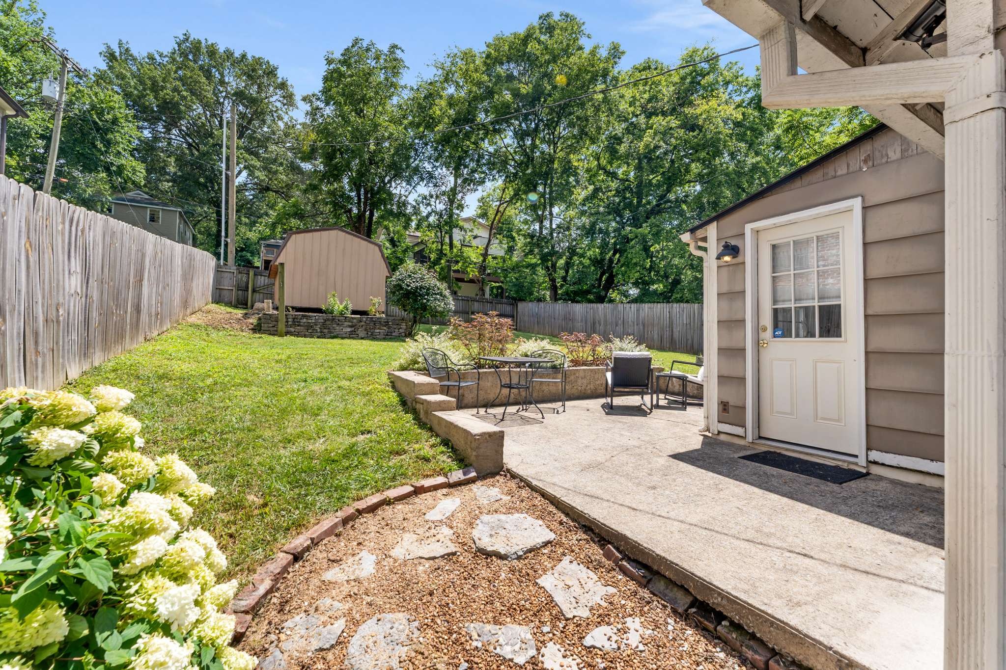 3905 Nevada Avenue Nashville, TN 37209 - Photo 23 of 39 a view of a backyard with table and chairs and wooden fence