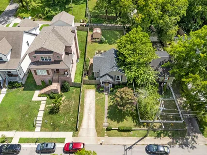 an aerial view of a houses with yard