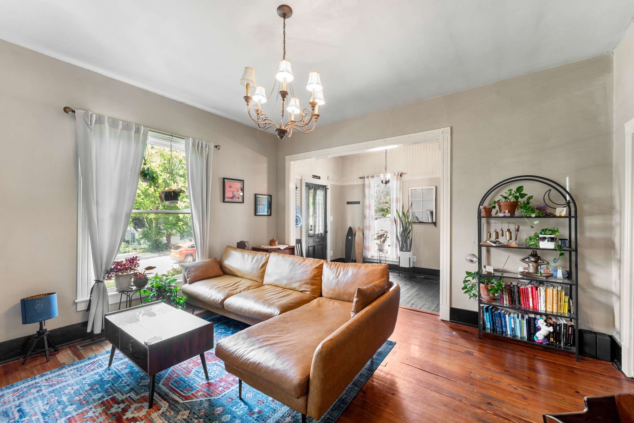 3905 Nevada Avenue Nashville, TN 37209 - Photo 8 of 39 a living room with furniture a chandelier and a bookshelf