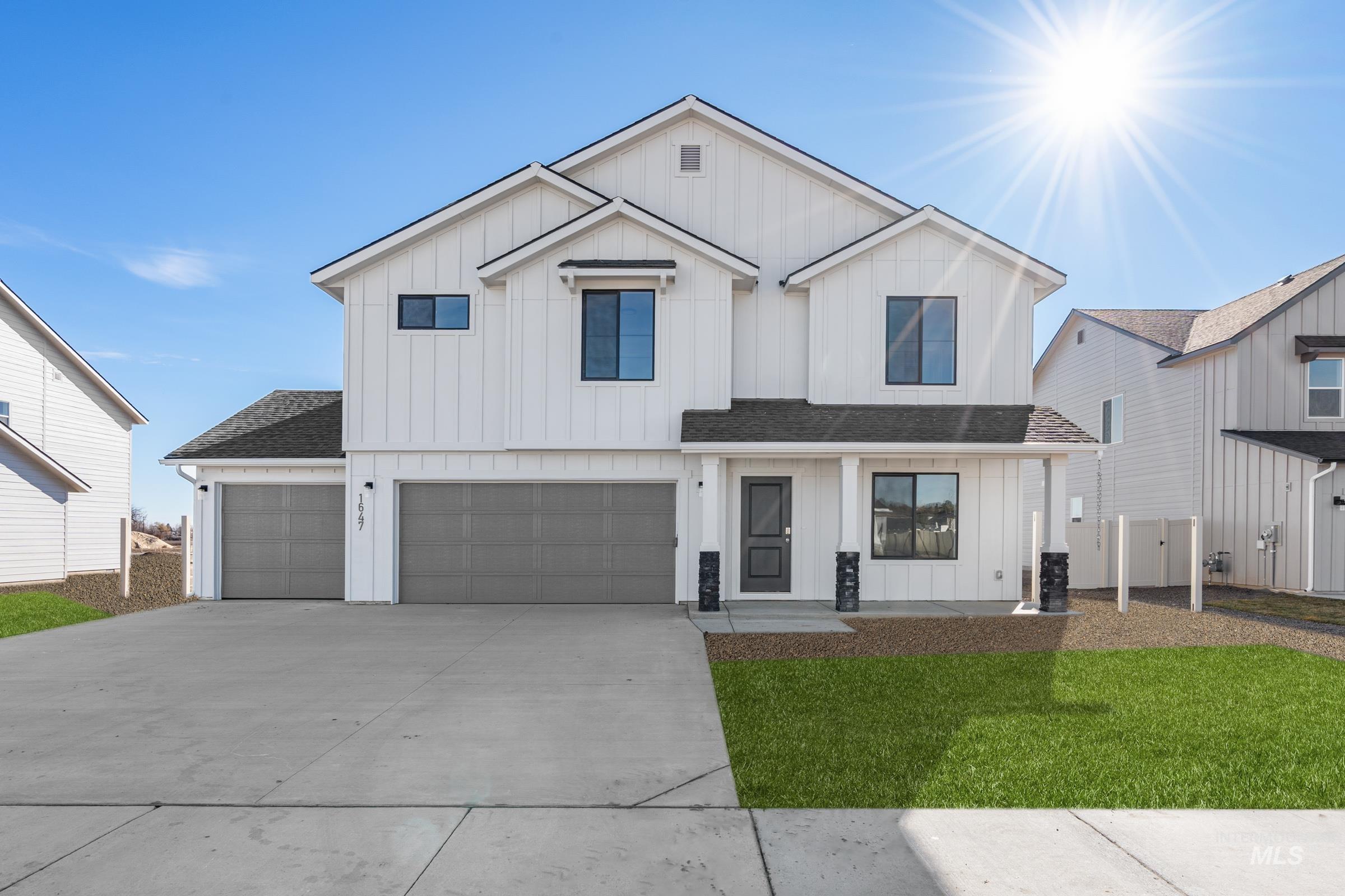 Modern farmhouse with board and batten siding, roof with shingles, driveway, a garage, and a porch