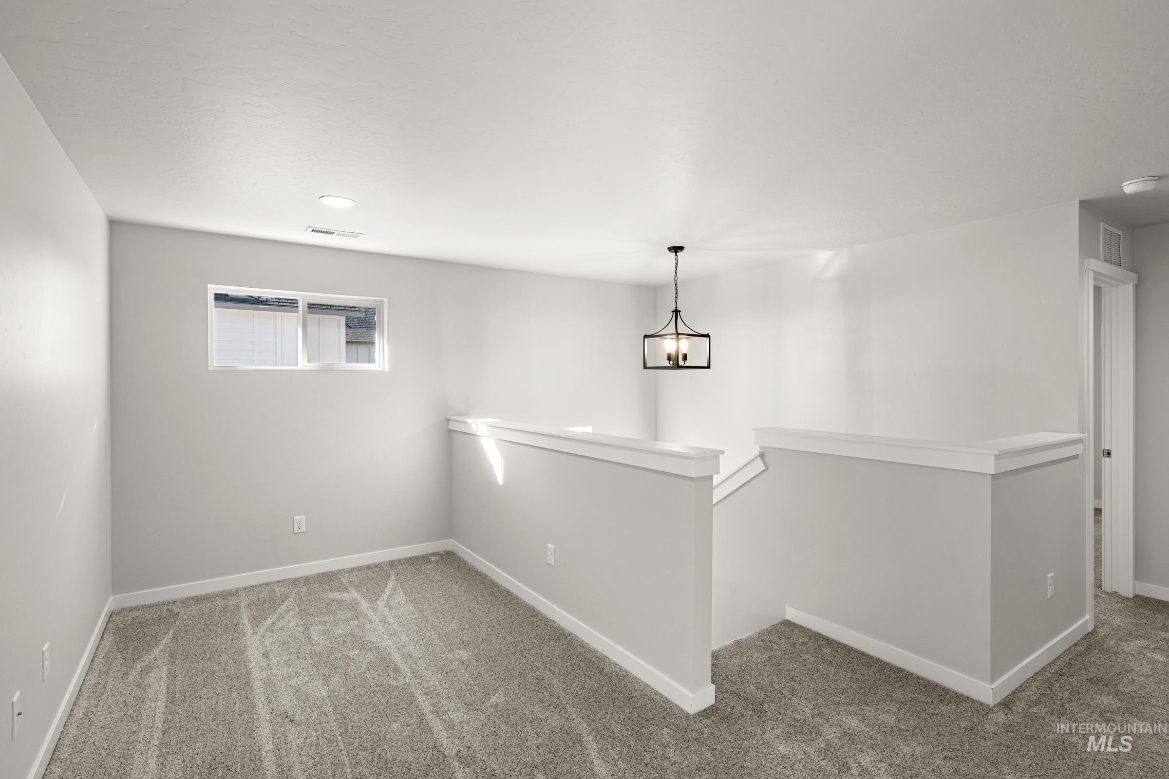 1647 Dyer Street Middleton, ID 83644 - Photo 13 of 25 Basement with carpet floors and hanging lights