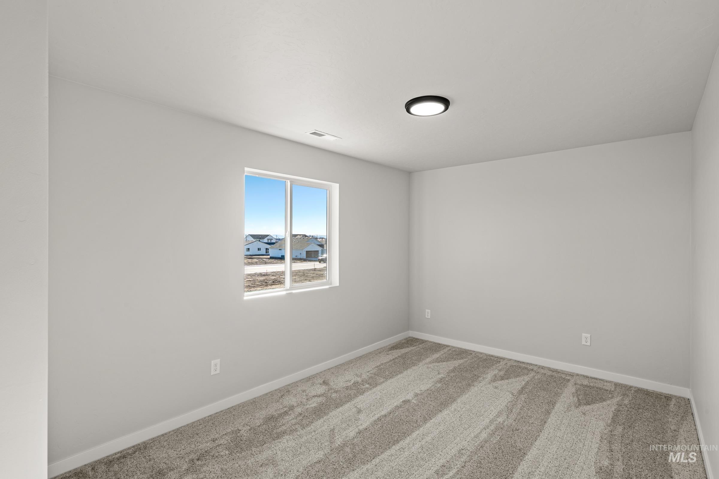 1647 Dyer Street Middleton, ID 83644 - Photo 14 of 25 Carpeted spare room featuring baseboards