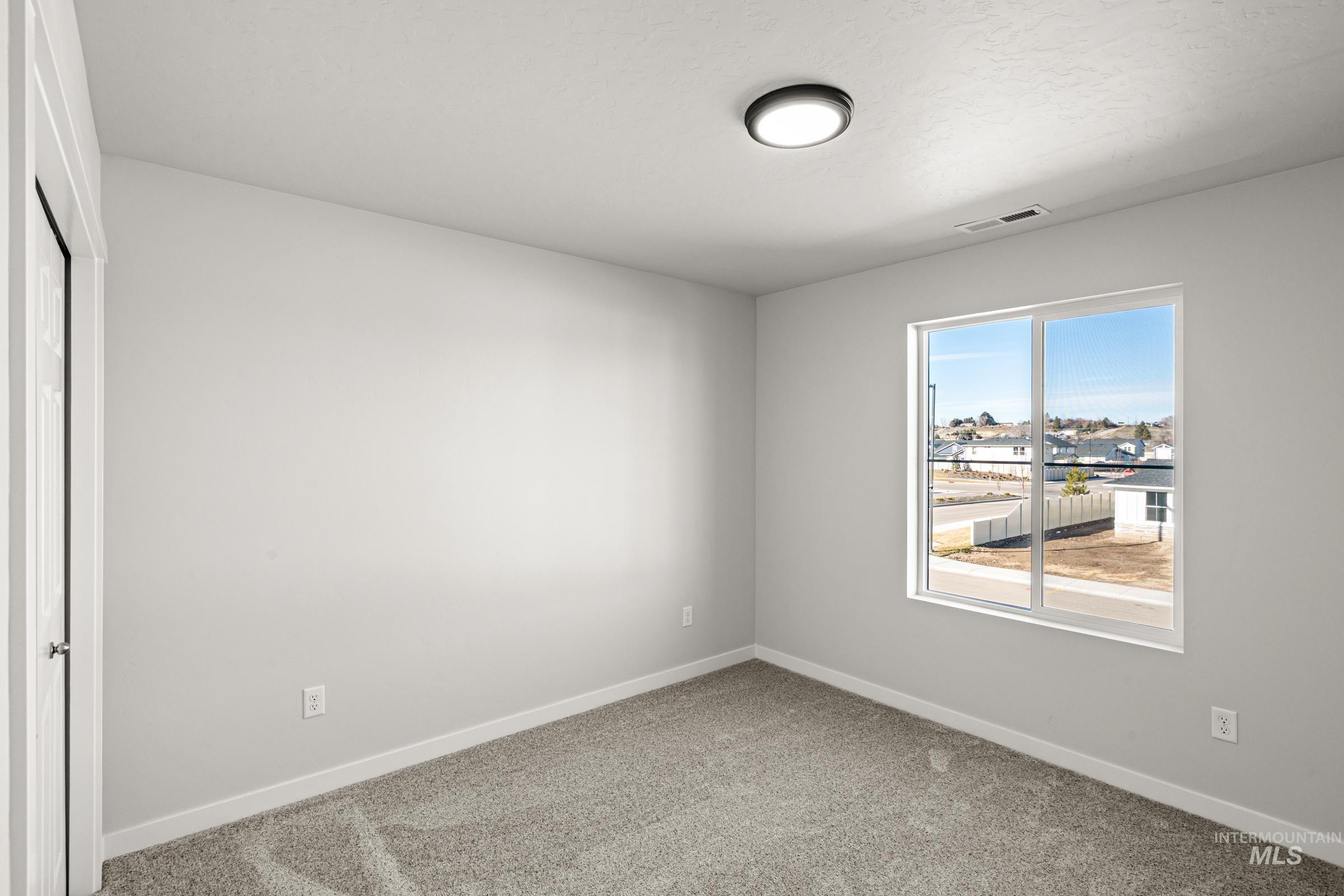 1647 Dyer Street Middleton, ID 83644 - Photo 16 of 25 Empty room featuring baseboards and carpet flooring
