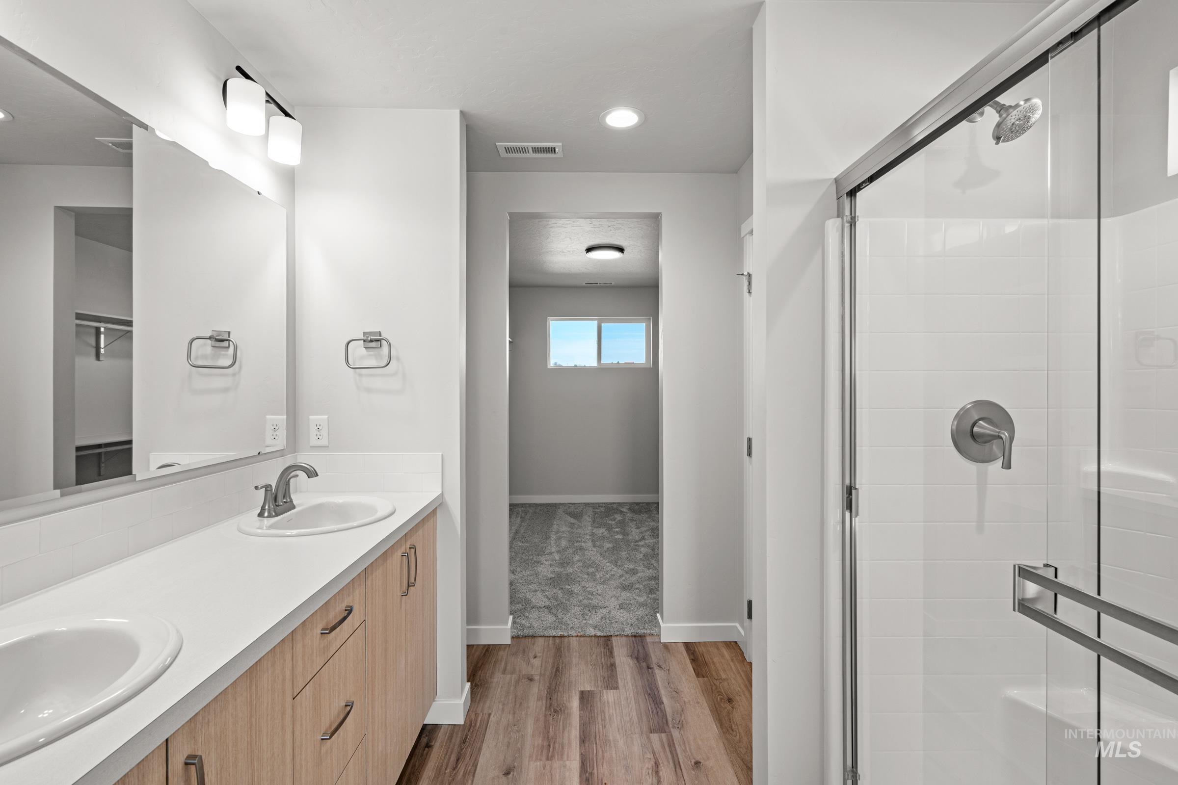1647 Dyer Street Middleton, ID 83644 - Photo 22 of 25 Bathroom featuring light wood-style flooring, double vanity, a stall shower, and recessed lighting