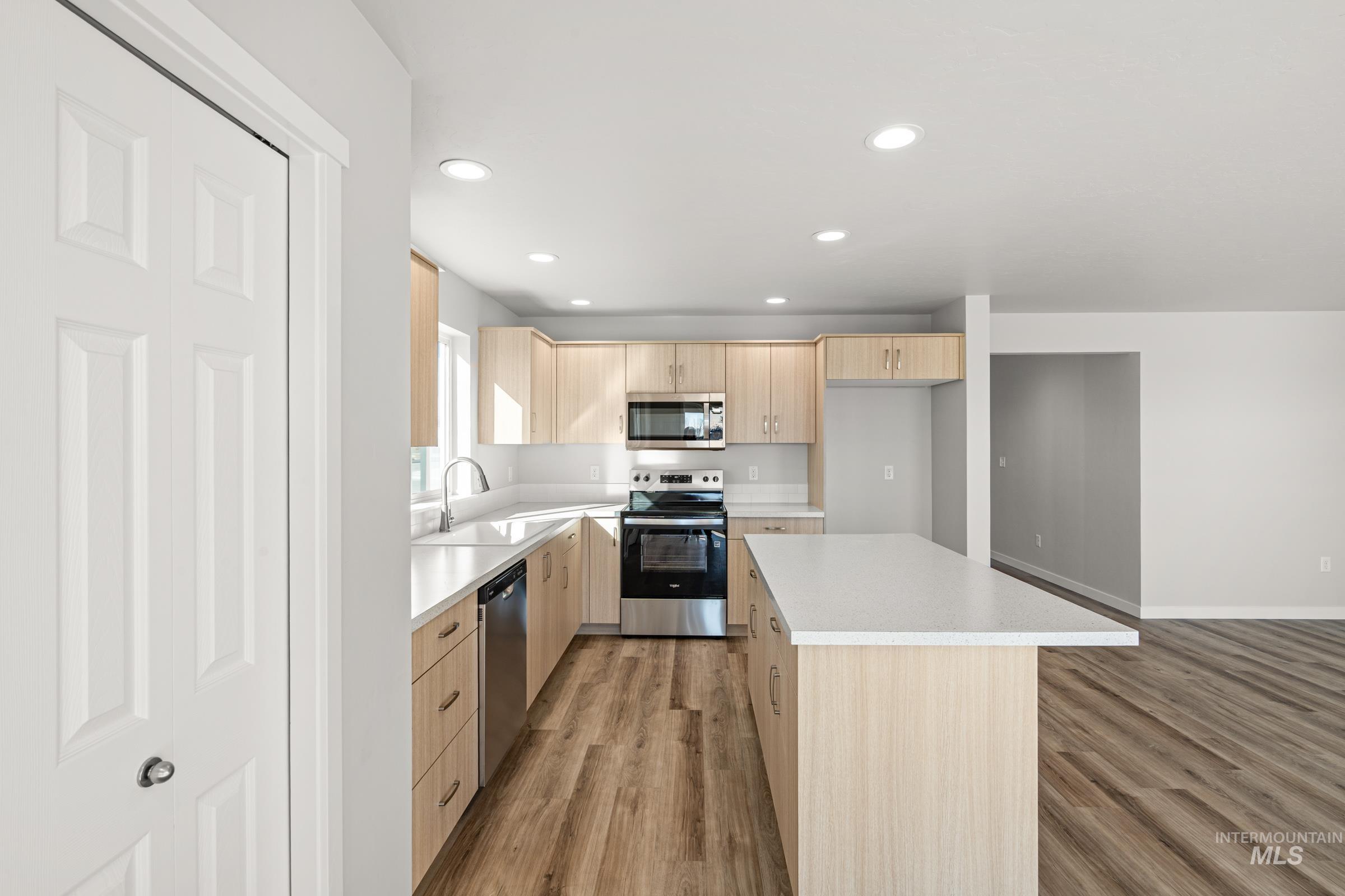 1647 Dyer Street Middleton, ID 83644 - Photo 3 of 25 Kitchen with light wood finish cabinets, stainless steel appliances, recessed lighting, light wood-type flooring, and a center island