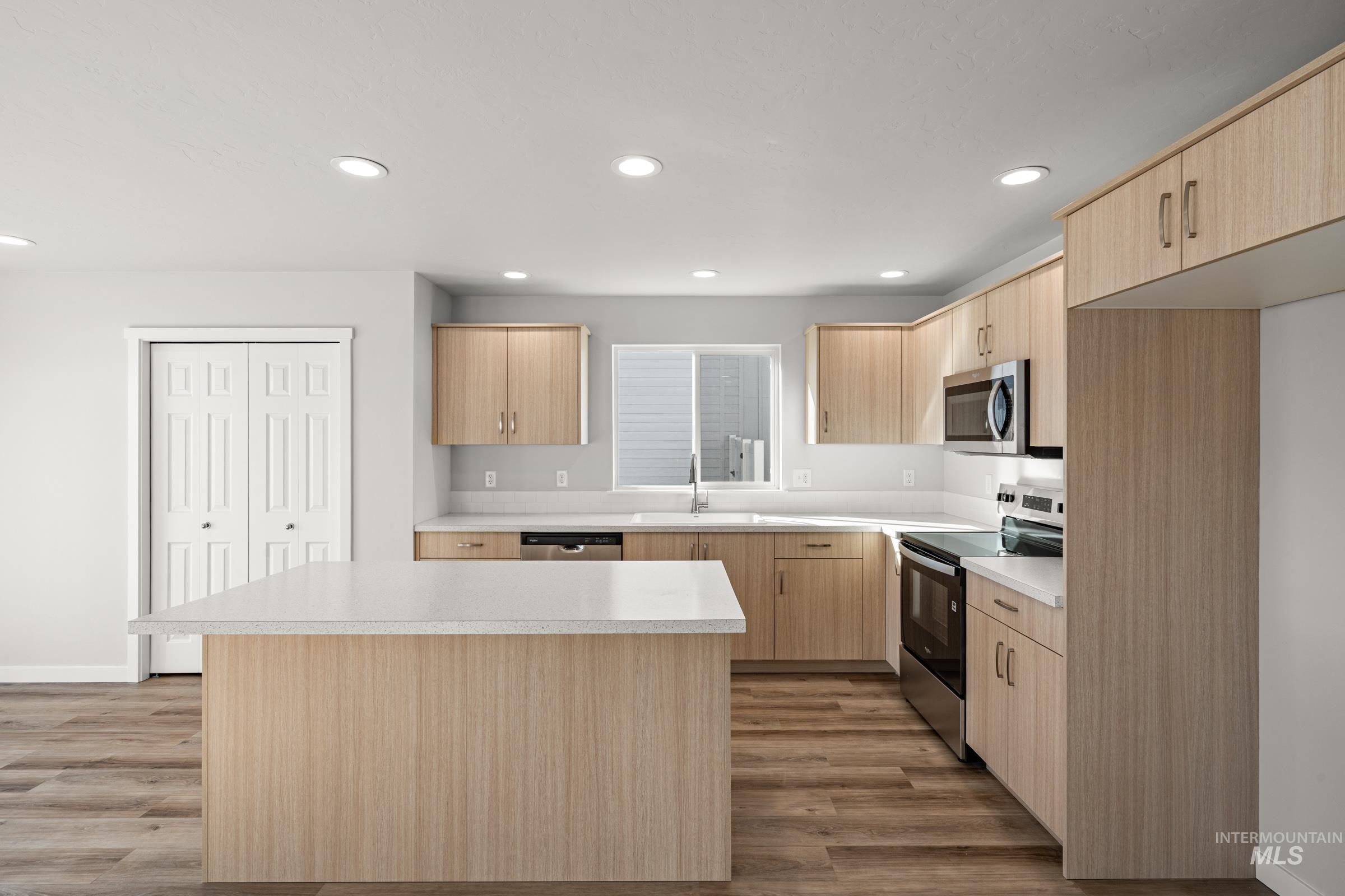 1647 Dyer Street Middleton, ID 83644 - Photo 5 of 25 Kitchen featuring light wood finish cabinetry, stainless steel appliances, light countertops, light wood-type flooring, and recessed lighting
