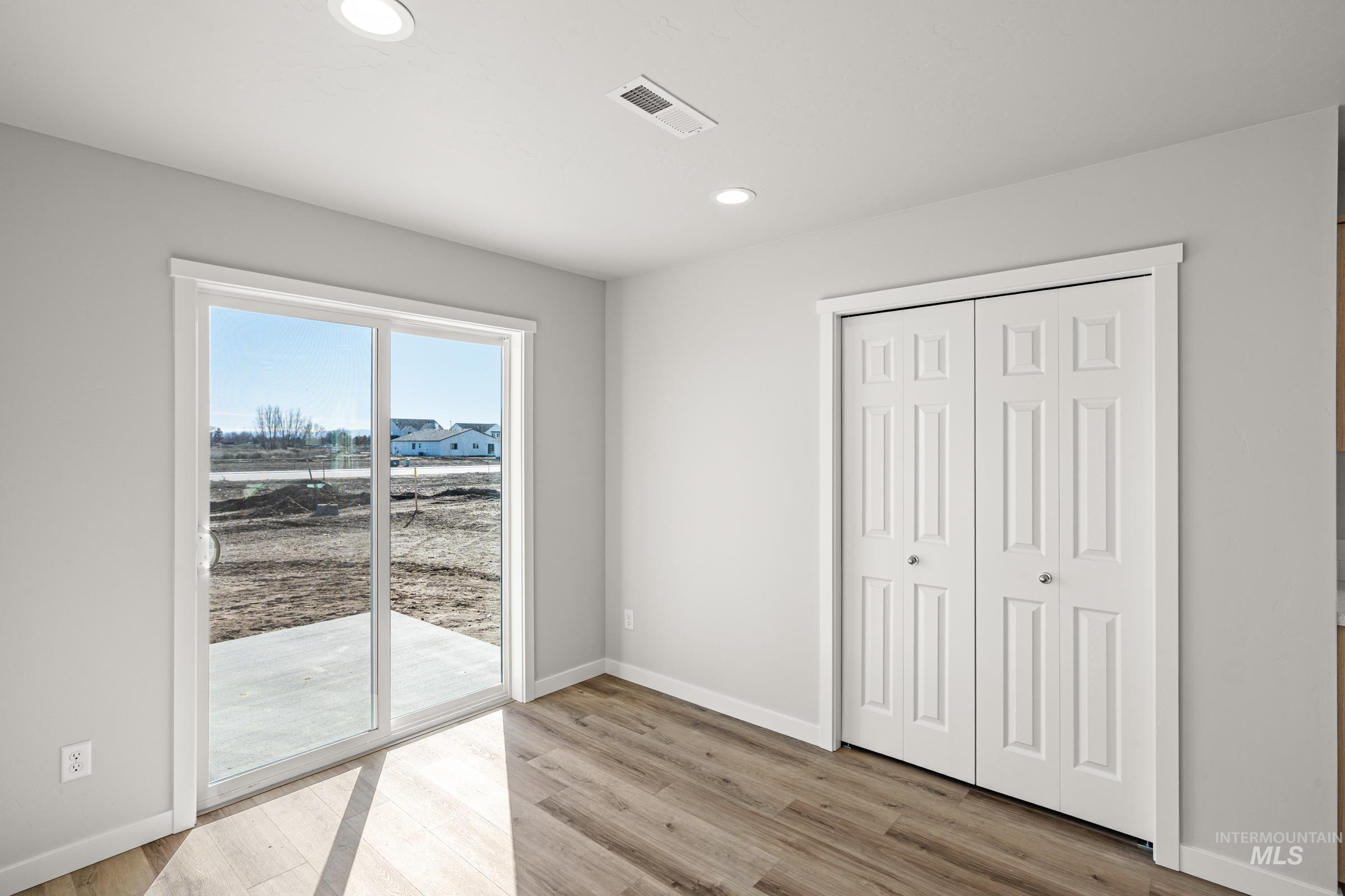 1647 Dyer Street Middleton, ID 83644 - Photo 7 of 25 Unfurnished bedroom featuring access to outside, light wood finished floors, a closet, and recessed lighting