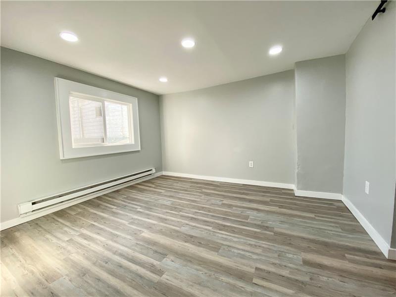 6630 Library Road South Park, PA 15129 - Photo 3 of 21 an empty room with wooden floor and windows