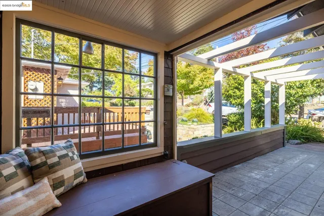 a view of a hallway with wooden floor windows and a living room
