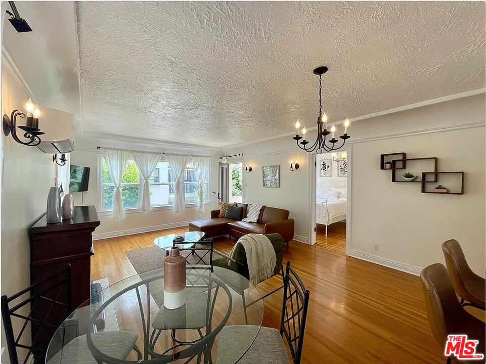 837 5th Street, Unit 839B Santa Monica, CA 90403 - Photo 16 of 23 a view of a dining room with furniture a chandelier and wooden floor