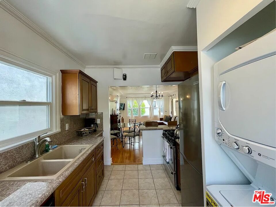 837 5th Street, Unit 839B Santa Monica, CA 90403 - Photo 2 of 23 a kitchen with stainless steel appliances granite countertop a sink dishwasher stove and refrigerator