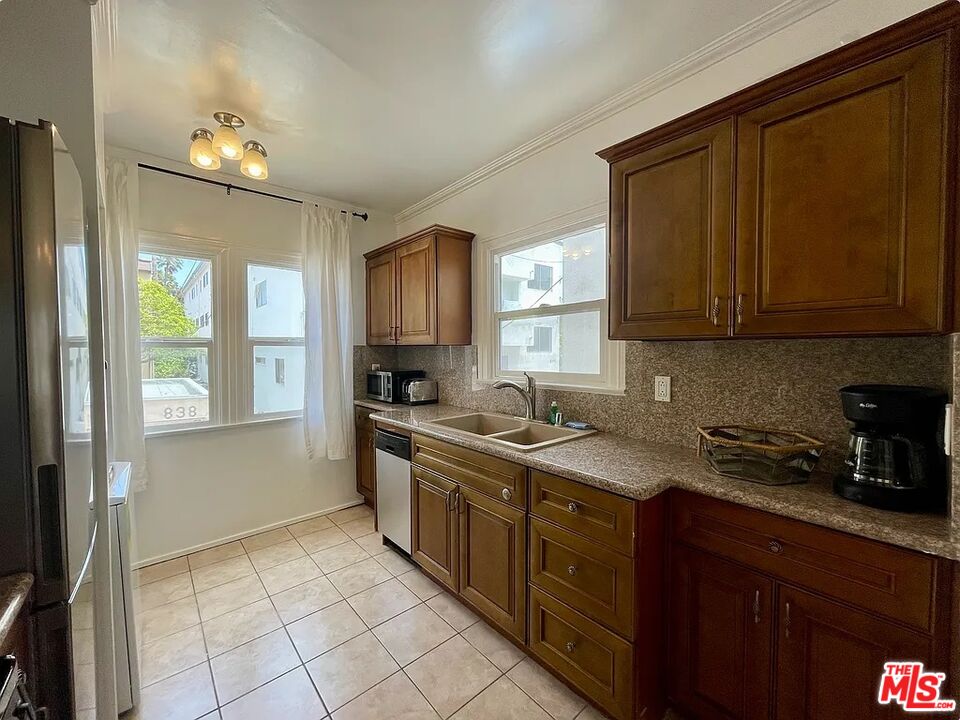 837 5th Street, Unit 839B Santa Monica, CA 90403 - Photo 23 of 23 a kitchen with a sink stove and cabinets