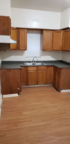 a view of an empty room with kitchen island