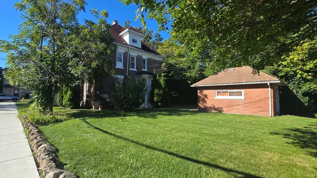 a front view of a house with yard and green space