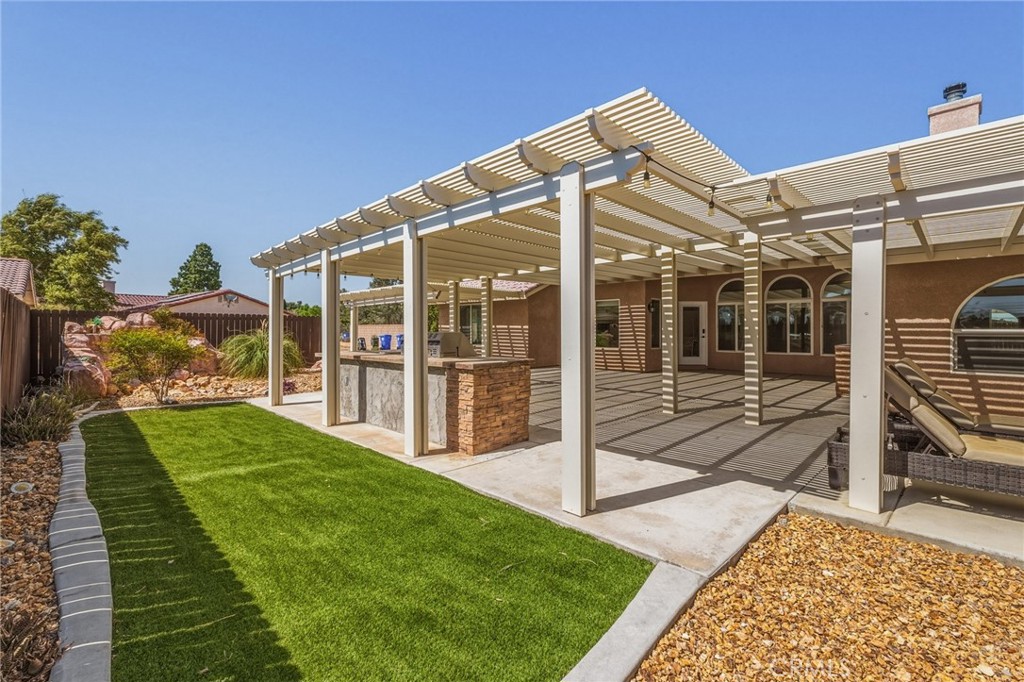 19501 Kinai Road Apple Valley, CA 92307 - Photo 44 of 49 a view of a house with backyard porch and sitting area