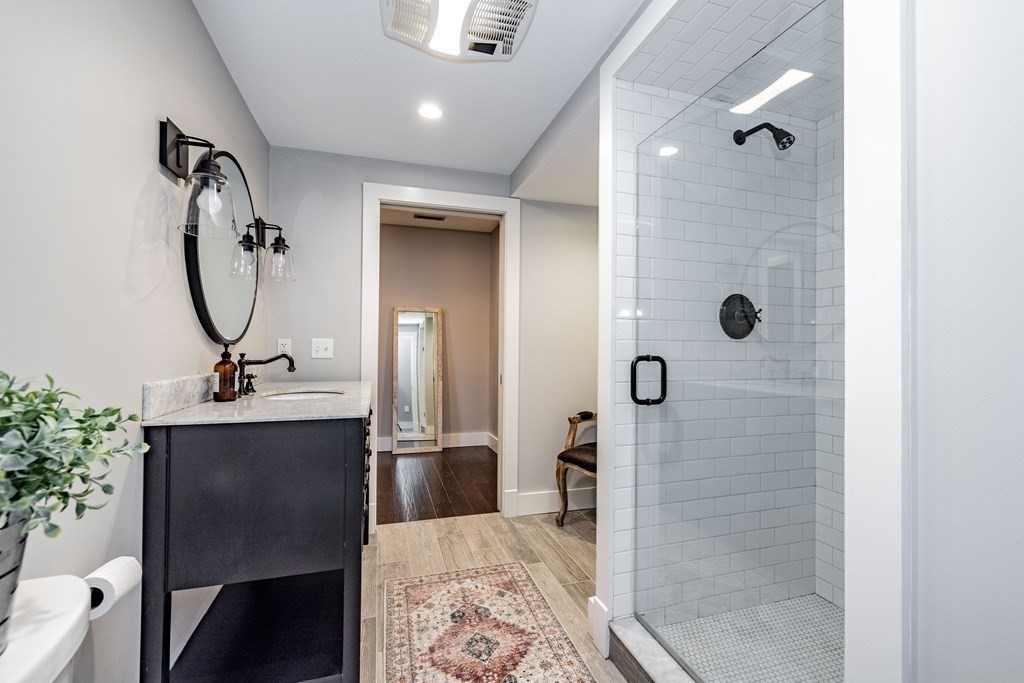 165 Converse Street, Unit 1 Longmeadow, MA 01106 - Photo 12 of 17 a bathroom with a sink a toilet and shower