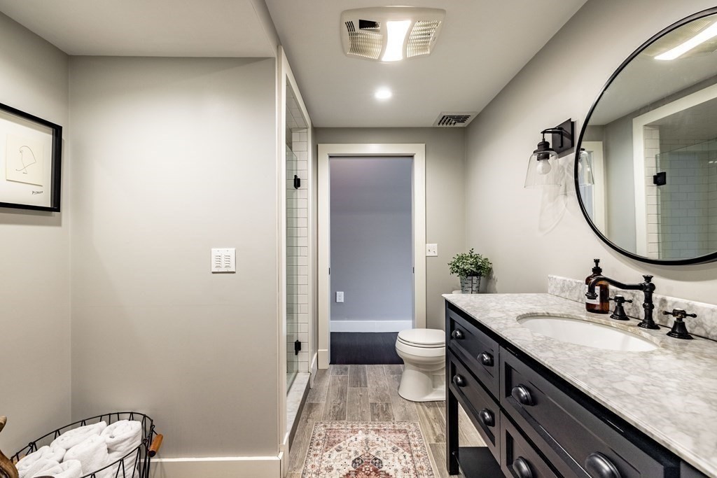 165 Converse Street, Unit 1 Longmeadow, MA 01106 - Photo 13 of 17 a bathroom with a granite countertop sink a mirror and a toilet