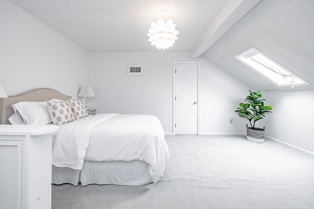 165 Converse Street, Unit 1 Longmeadow, MA 01106 - Photo 15 of 17 a bedroom with a bed and a chandelier