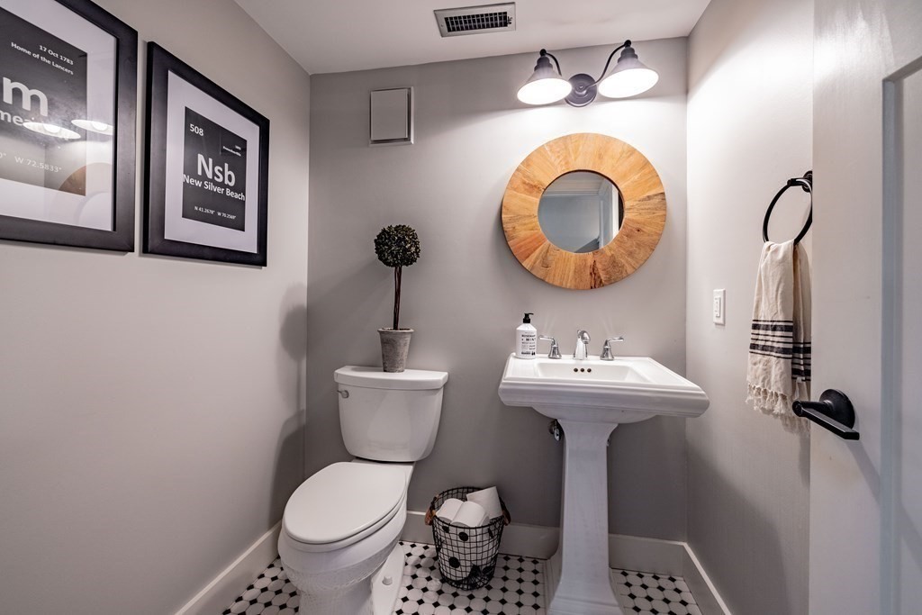 165 Converse Street, Unit 1 Longmeadow, MA 01106 - Photo 16 of 17 a bathroom with a toilet sink and mirror