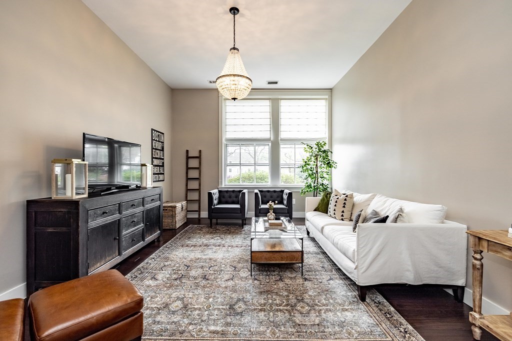 165 Converse Street, Unit 1 Longmeadow, MA 01106 - Photo 3 of 17 a living room with furniture and a flat screen tv