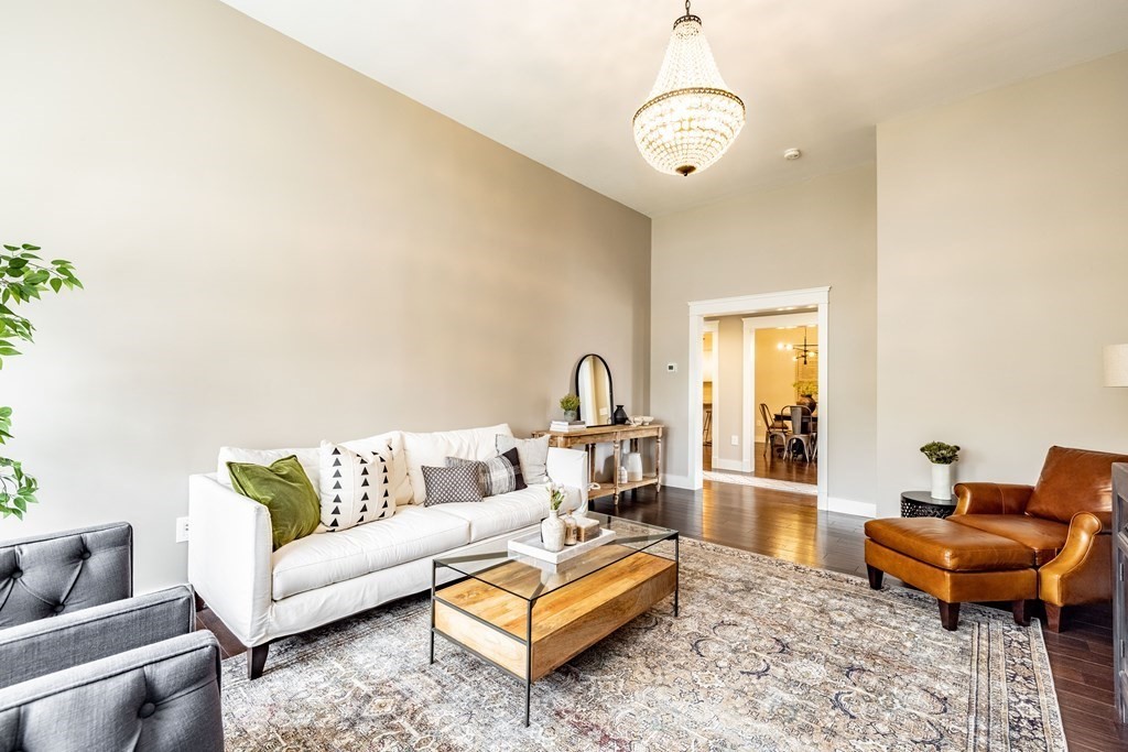165 Converse Street, Unit 1 Longmeadow, MA 01106 - Photo 4 of 17 a living room with furniture and a chandelier
