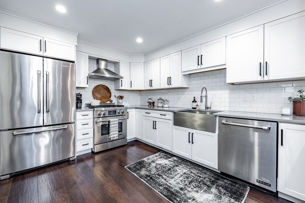 165 Converse Street, Unit 1 Longmeadow, MA 01106 - Photo 8 of 17 a kitchen with stainless steel appliances and white cabinets