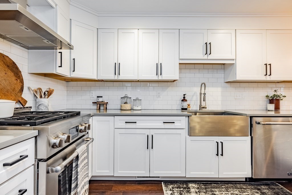 165 Converse Street, Unit 1 Longmeadow, MA 01106 - Photo 9 of 17 a kitchen with stainless steel appliances granite countertop a stove and white cabinets